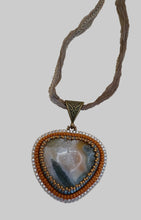 Load image into Gallery viewer, Necklace with a heart-shaped pendant on a beige background
