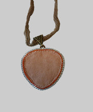 Load image into Gallery viewer, Necklace with a heart-shaped pendant on a light background